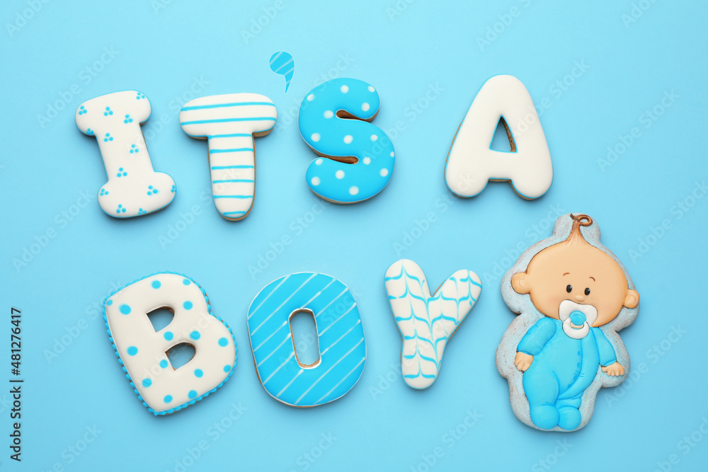 Phrase IT IS A BOY made of tasty cookies on light blue background, flat lay. Baby shower party