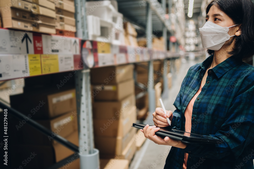Fototapeta premium Woman worker using digital tablet checking the stock inventory, Smart warehouse management system, Supply chain and logistic network technology concept.