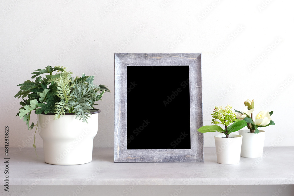 Fototapeta premium Blank grey vintage wooden frame on table and white wall banckground , banner, with copy space for mock up, template