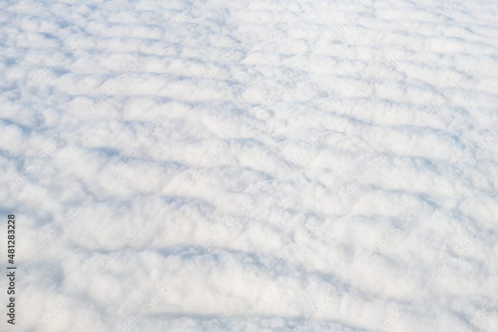 Flying above Reykjavik, Iceland with cloudscape aerial high angle view above of abstract cloudy landscape sky and pattern of white fluffy clouds from airplane Flying above Reykjavik, Iceland with cloudscape aerial high angle view above of abstract cloudy landscape sky and pattern of white fluffy clouds from airplane