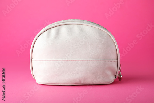 White leather cosmetic bag on pink background