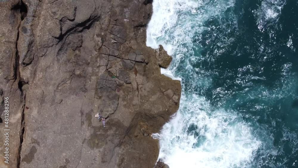 Birds eye pov over waves breaking on a seacliff. Birds eye pov over waves breaking on a seacliff.