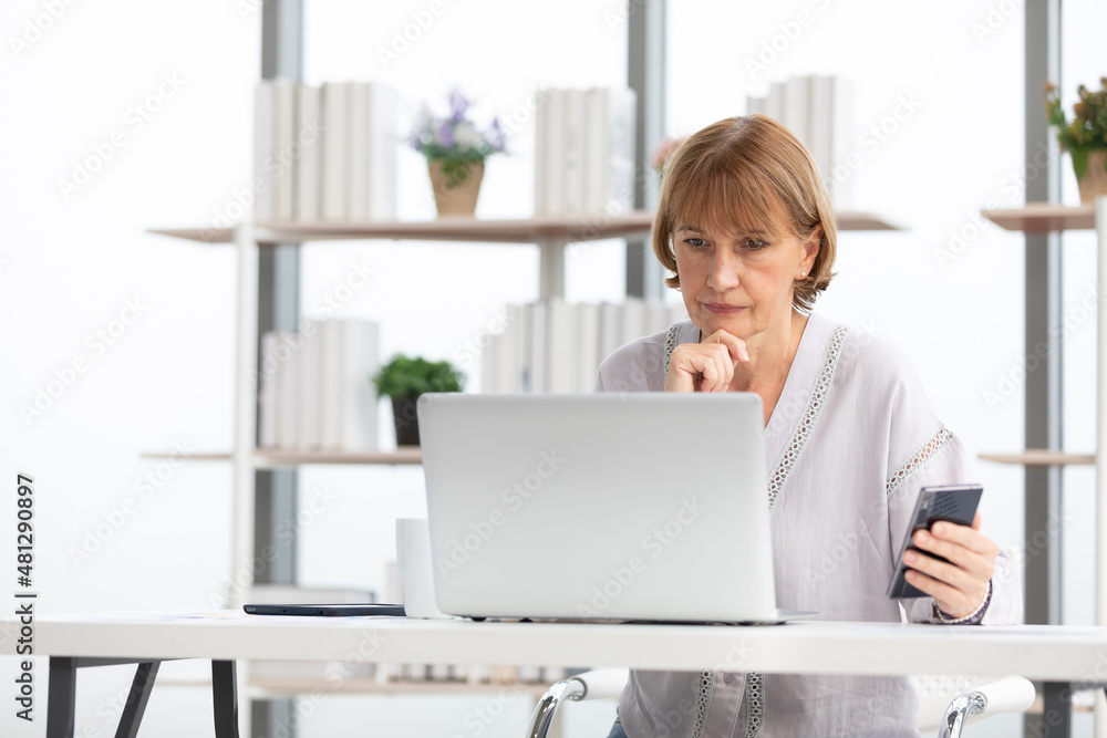 senior businesswoman or freelancer looking smartphone for checking something for work senior businesswoman or freelancer looking smartphone for checking something for work