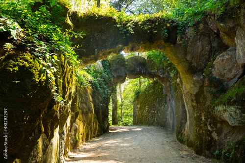 Picturesque alley with stone arches in park of Quinta da Regaleira, Sintra, Portugal photo