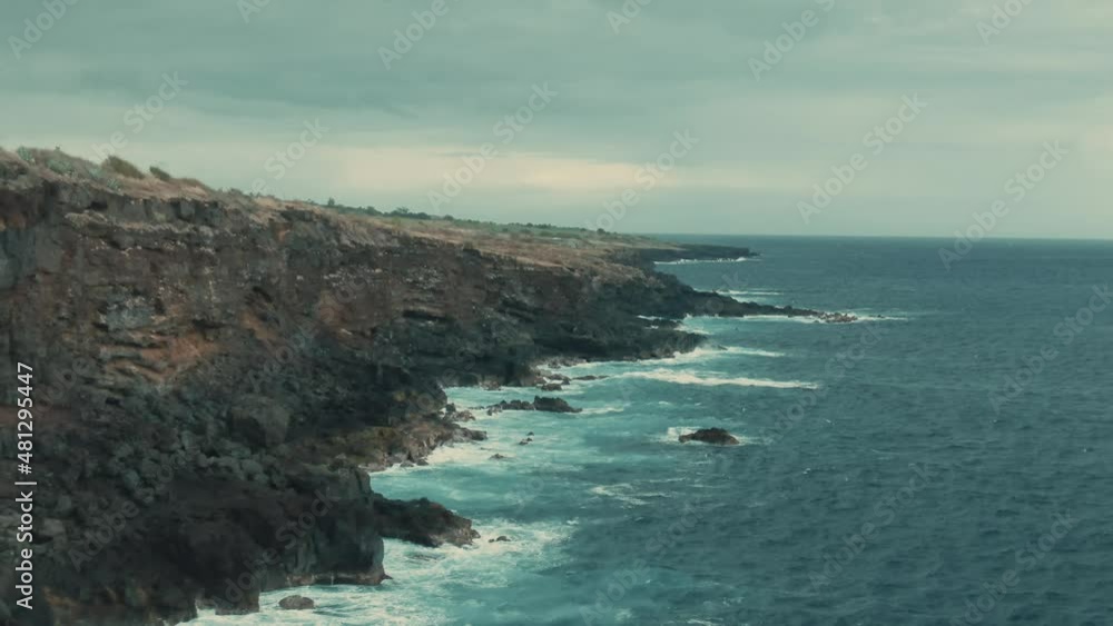 4k Aerial high volcanic cliff on calm ocean Drone dolly in shot 4k Aerial high volcanic cliff on calm ocean Drone dolly in shot