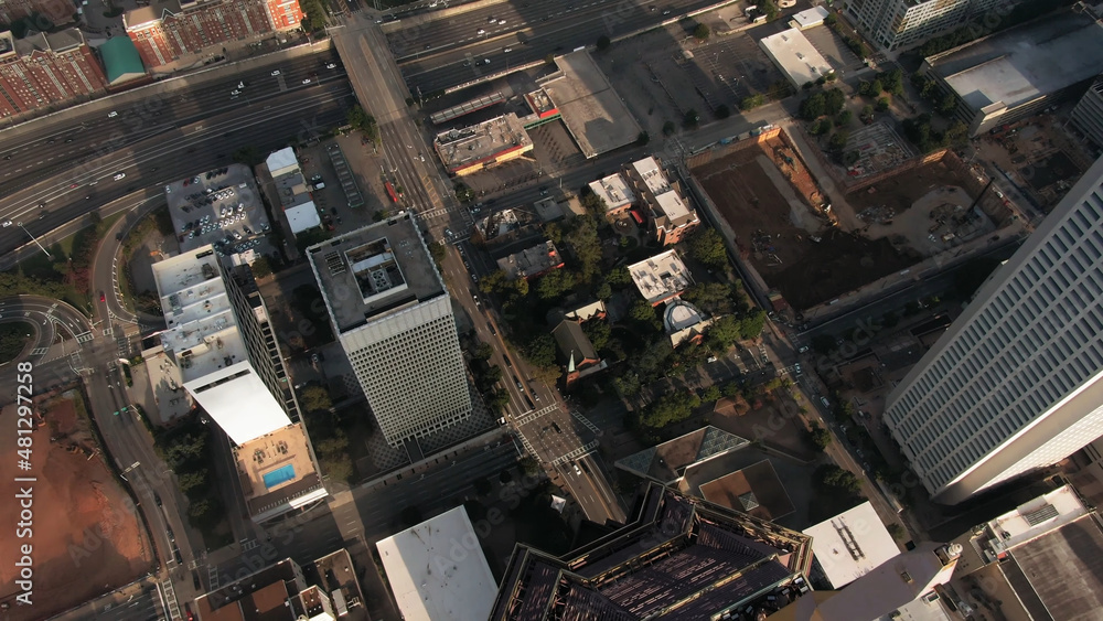 Top view metrpolis modern skyscrappers business buildings aerial flight shot by drone urban style architecture streets cars vehicle movement district landscape commercial infrastructure office rooftop