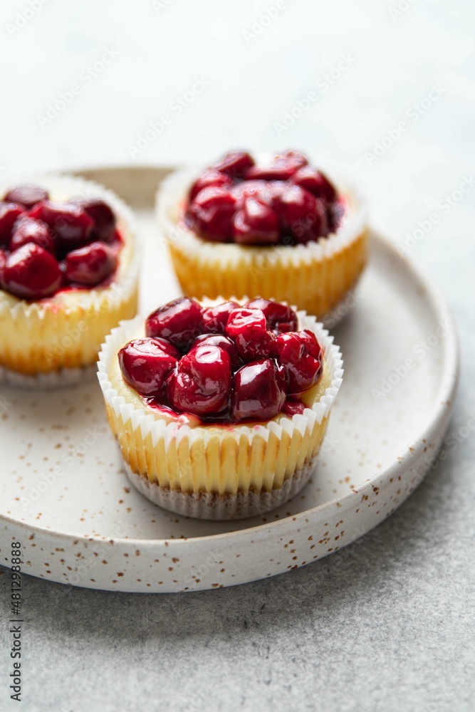 Mini cheesecake with cherry jam. One bite dessert. Tiny cheesecakes with berry. Valentine homemade present. Selective focus. Mini cheesecake with cherry jam. One bite dessert. Tiny cheesecakes with berry. Valentine homemade present. Selective focus.
