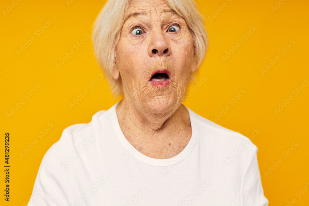 Portrait of an old friendly woman in white t-shirt posing fun close-up emotions Portrait of an old friendly woman in white t-shirt posing fun close-up emotions