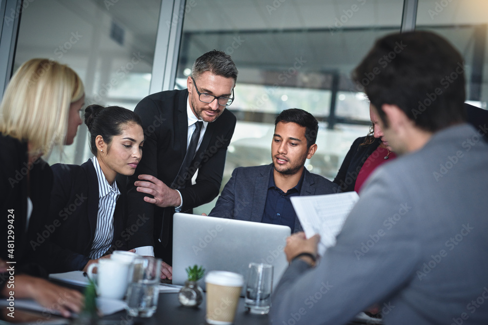 What is everybody's view on this. Shot of a group of businesspeople having a meeting together over a laptop in a boardroom at the office.