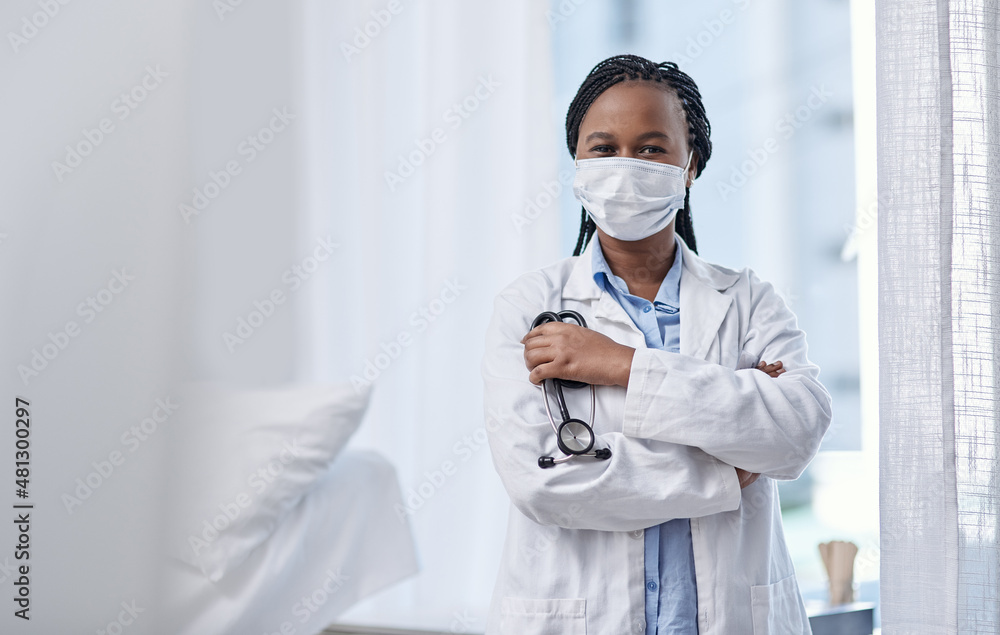 Putting passion into community care. Portrait of a young doctor wearing a face mask and holding a stethoscope in a hospital. Putting passion into community care. Portrait of a young doctor wearing a face mask and holding a stethoscope in a hospital.