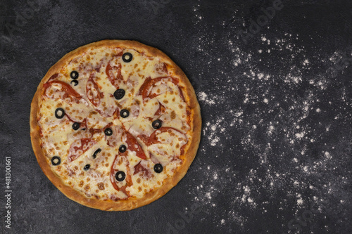 pizza on a dark board