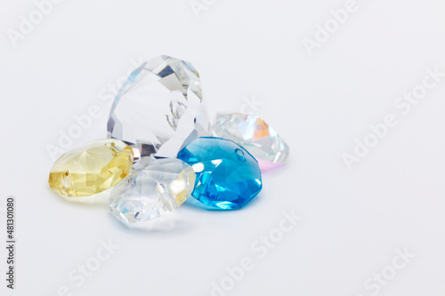 plastic gemstones in different colors on white background