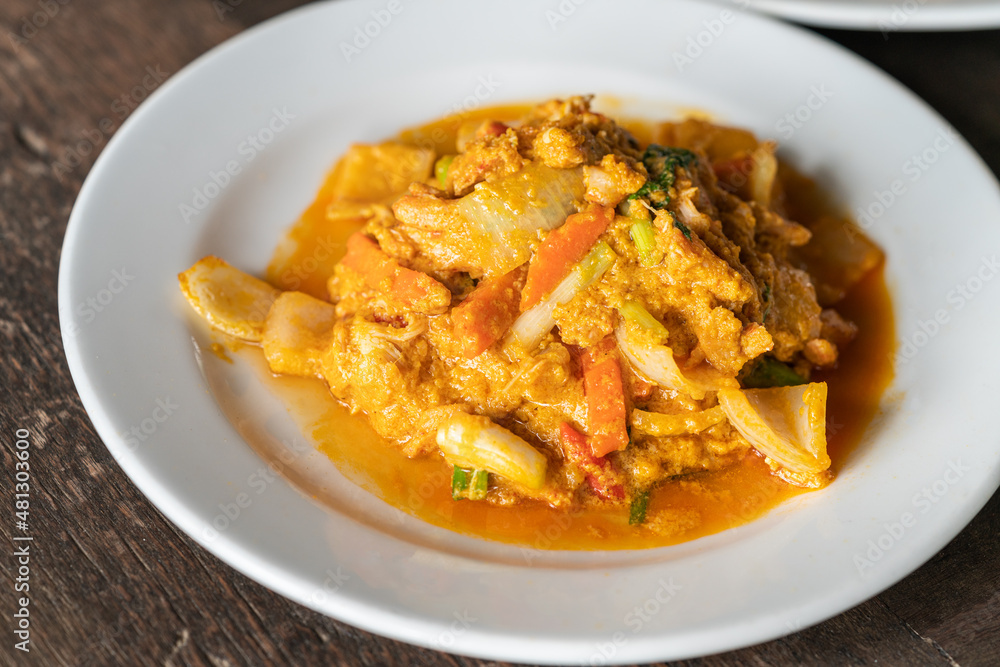 Close up stir-fried Crabmeat with curry powder and egg, healthy seafood Thai food on wooden table, natural light. Close up stir-fried Crabmeat with curry powder and egg, healthy seafood Thai food on wooden table, natural light.
