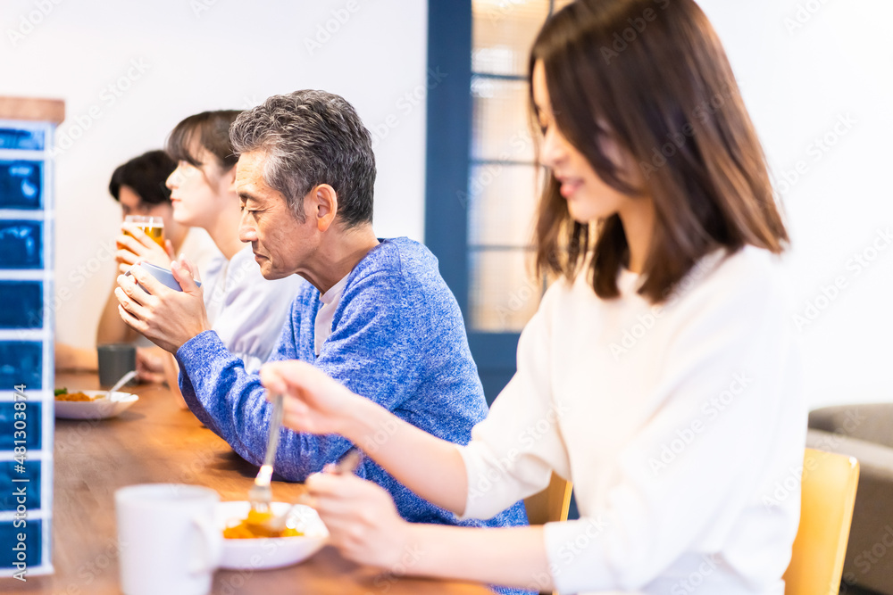 レストランのカウンター席でご飯を食べる人々
