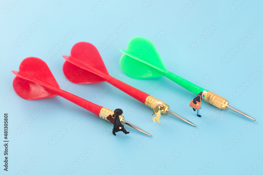 Miniature creative dart pointing to strive to achieve Miniature creative dart pointing to strive to achieve