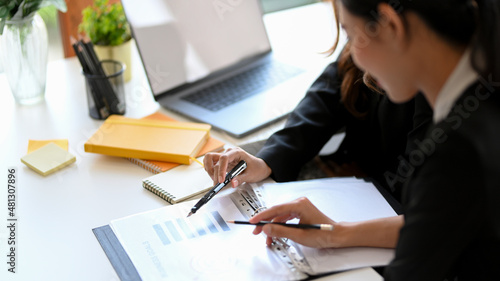 A female financial boss briefing an assignment to her employee.