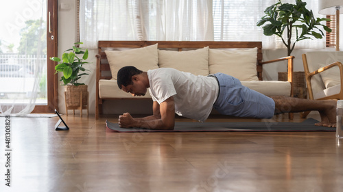 Black African American male doing plank exercise © eggeeggjiew