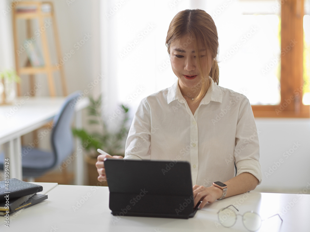 Businesswoman or female using digital tablet computer at her workplace. Businesswoman or female using digital tablet computer at her workplace.