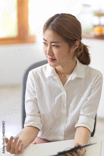 Businesswoman or manager sitting at her office desk.