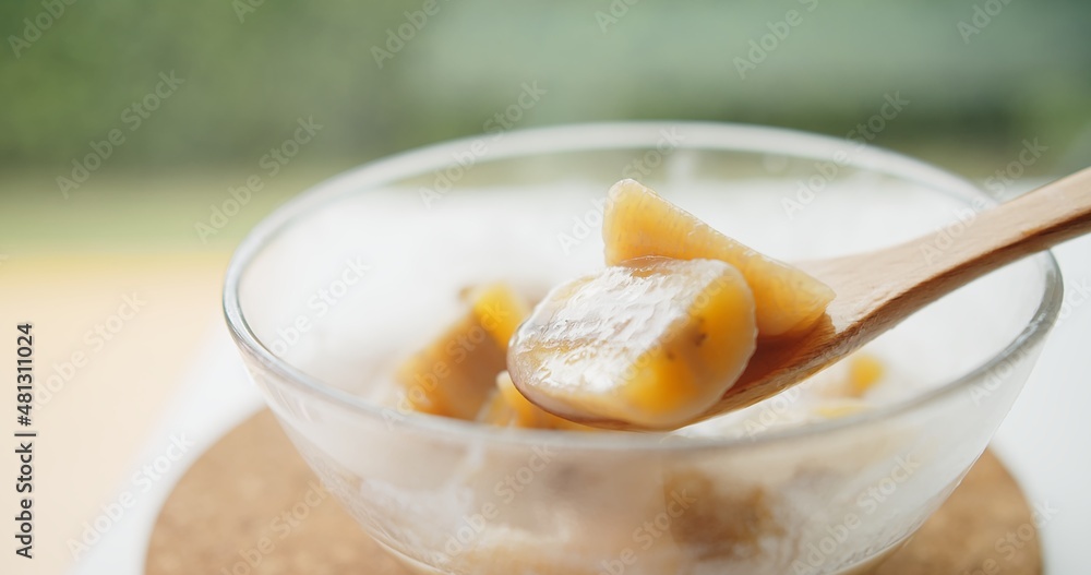 Close up wooden spoon holding Thai traditional sweet dessert food banana in coconut milk, Thai Cuisine
Close up wooden spoon holding Thai traditional sweet dessert food banana in coconut milk, Thai Cuisine