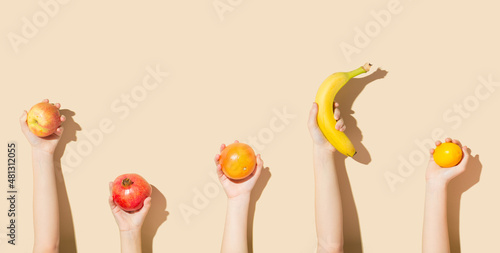 Children's hands holding fruit. Healthy food concept.