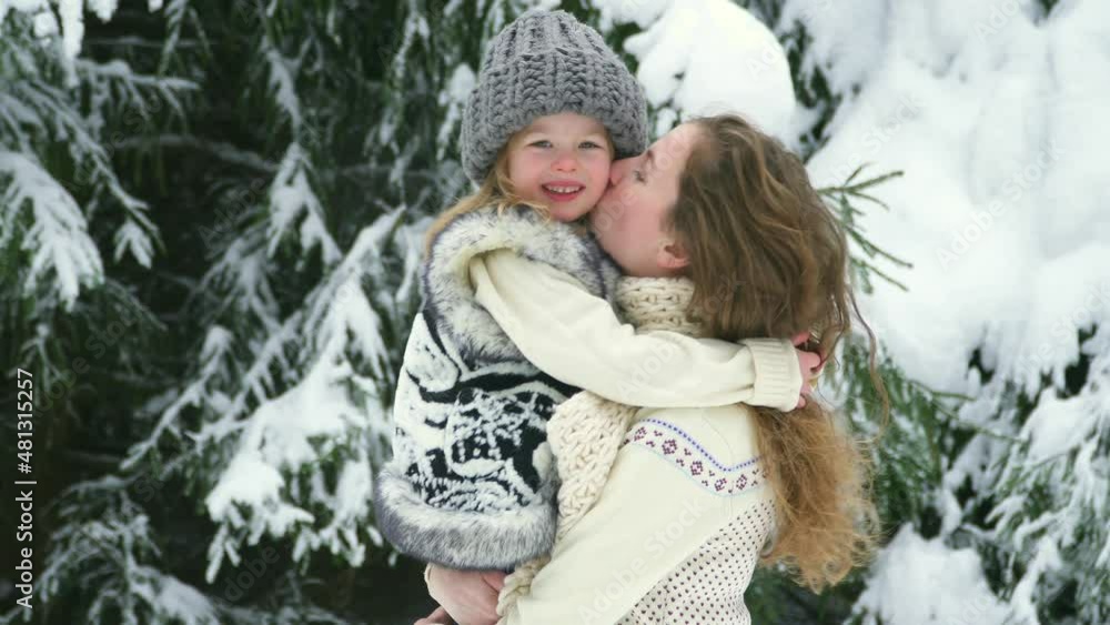 Happy family hug. Mom hold daughter smile in arms winter forest. Two sisters walk among white snow. Walks outside. Winter games in garden Christmas and New Year. Portrait fun caucasian woman and girl. Happy family hug. Mom hold daughter smile in arms winter forest. Two sisters walk among white snow. Walks outside. Winter games in garden Christmas and New Year. Portrait fun caucasian woman and girl.