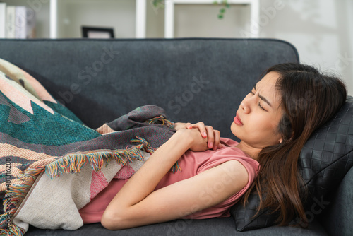 Young woman lying sick on the sofa with seasonal infections, flu.