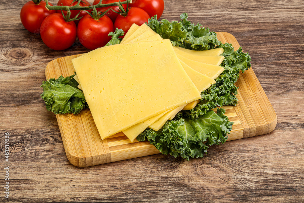 Sliced Gauda cheese over board Sliced Gauda cheese over board