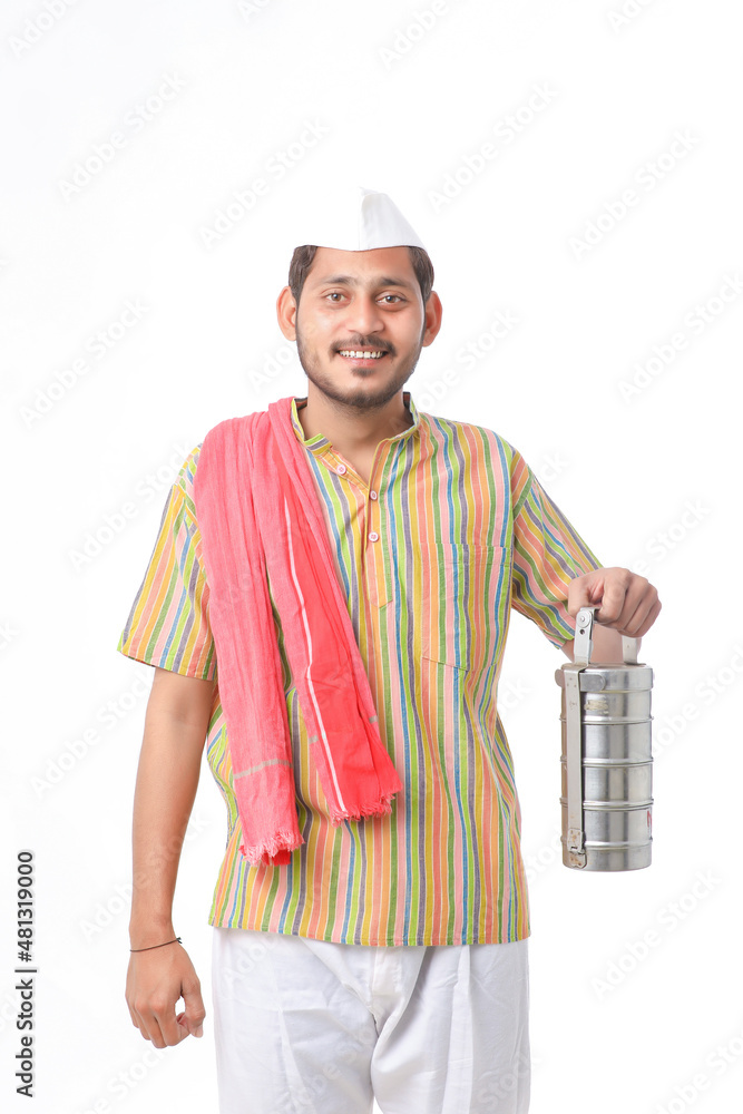 Young indian common man in traditional wear holding tiffin box in hand