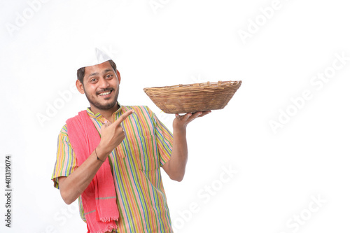 Indian man holding wooden bowl in hand on white background. photo