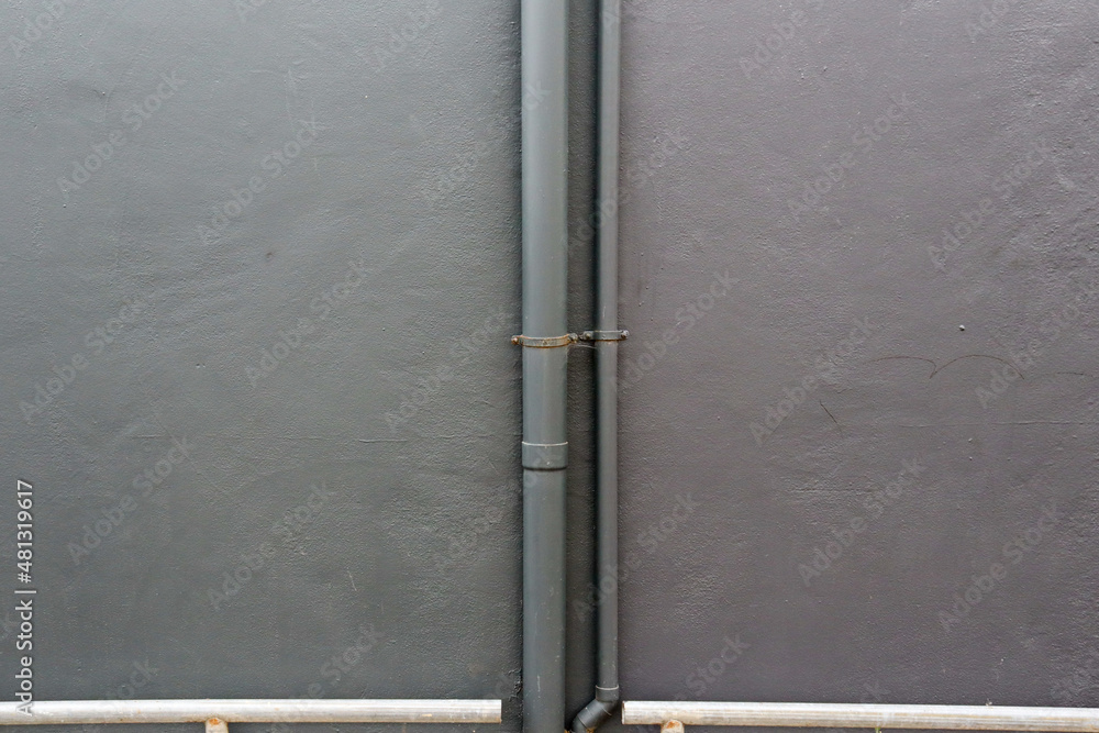 grey concrete wall and drain pipe