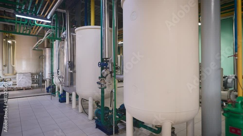 Shop of an industrial enterprise for the production of sunflower oil. The process of product refining takes place in special containers. photo