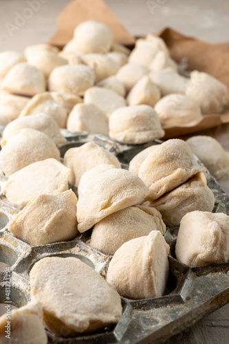 Homemade Russian dumplings with meat. Vertical photo. Close-up.