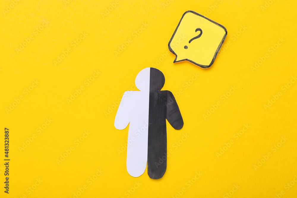 Paper human figure with question mark on yellow background Paper human figure with question mark on yellow background