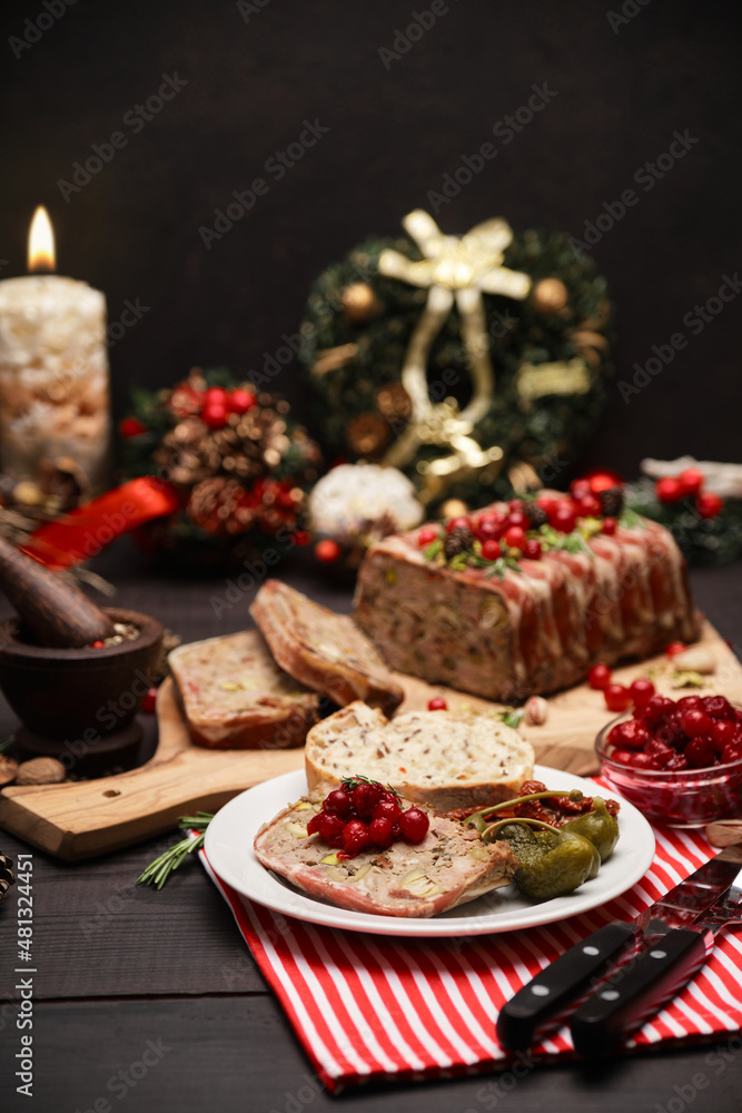 Traditional French terrine covered with bacon on dark wooden background with Christmas decorations Traditional French terrine covered with bacon on dark wooden background with Christmas decorations