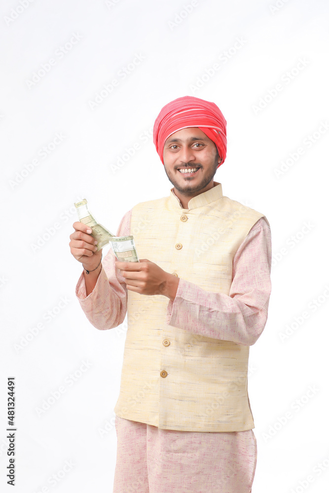 Young indian farmer showing money on white background. Young indian farmer showing money on white background.
