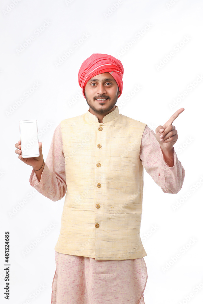 Young indian man showing smartphone and giving expression on white background. Young indian man showing smartphone and giving expression on white background.