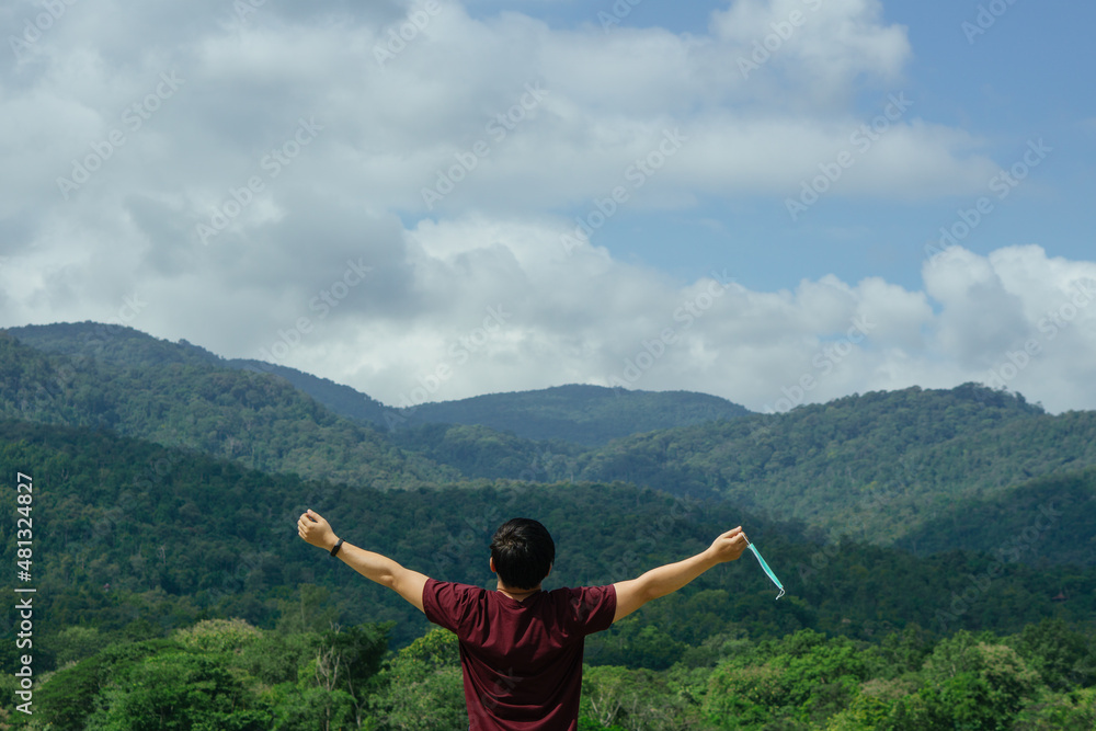 Man taking off mask outdoor.Coronavirus ended.Take off the mask.End of quarantine, covid-19.blue sky background, enjoys life, breathes fresh air after coronavirus pandemic. Man taking off mask outdoor.Coronavirus ended.Take off the mask.End of quarantine, covid-19.blue sky background, enjoys life, breathes fresh air after coronavirus pandemic.