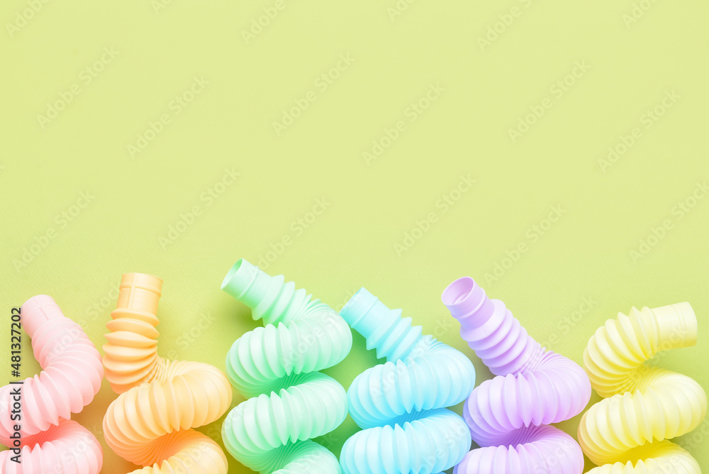Different colorful Pop Tubes on green background Different colorful Pop Tubes on green background