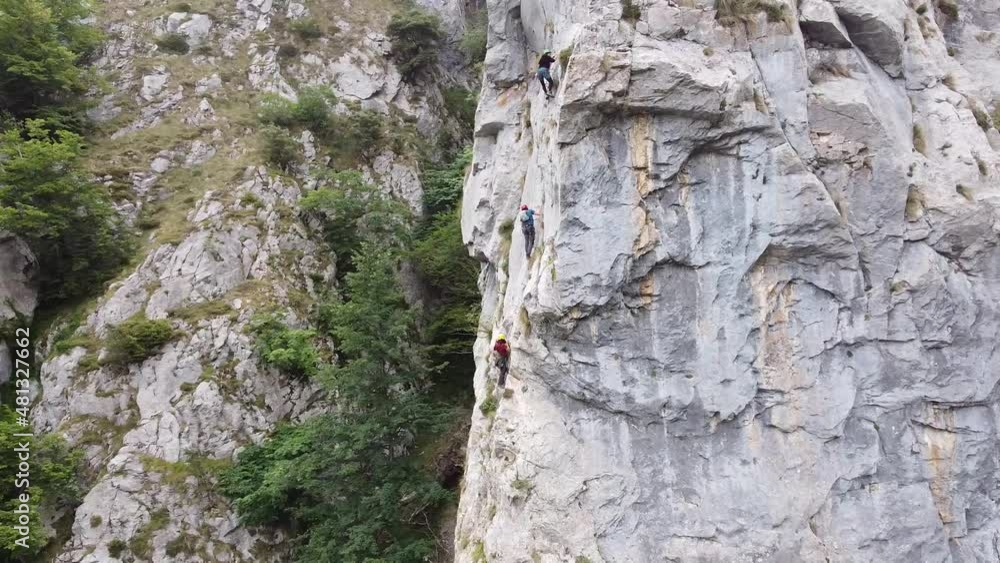 people climbing a wall in the mountains people climbing a wall in the mountains