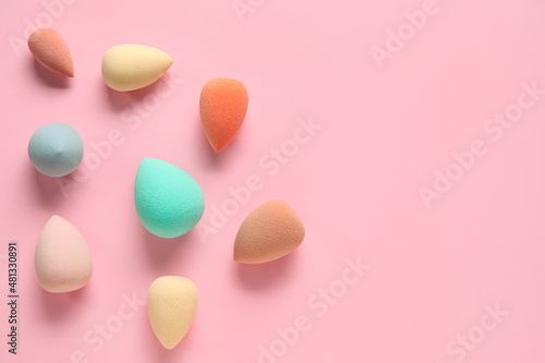 Different makeup sponges on pink background
