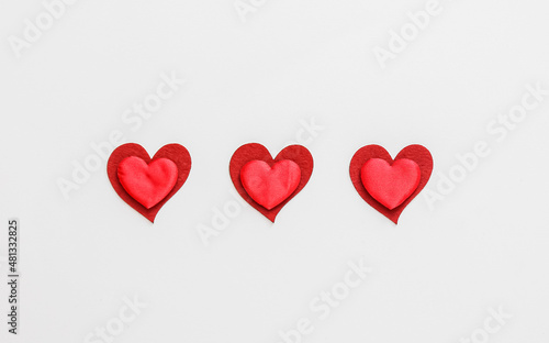 Composition with paper hearts on light background. St. Valentine's Day