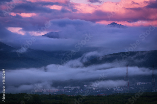 Pink dawn and fog against the backdrop of the mountains © Vita Fortuna