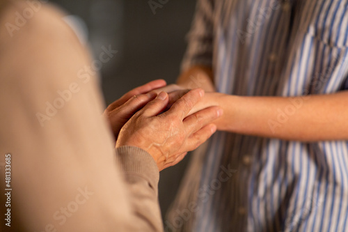 people  family and charity concept - close up of women holding hands