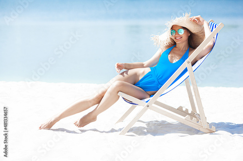 Attractive young woman on the beach. Sexy young lady on the sea shore.Female relaxing on resort. Model on seaside.