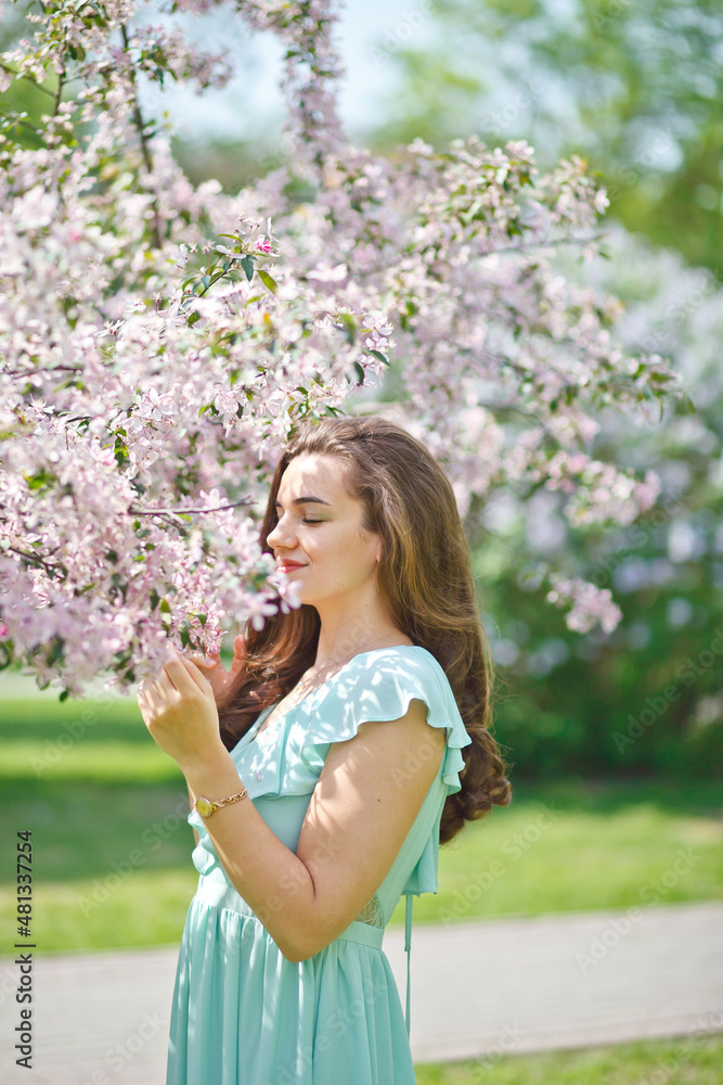 A woman in a beautiful long dress in a spring garden. Allergy free concept. A woman in a beautiful long dress in a spring garden. Allergy free concept.