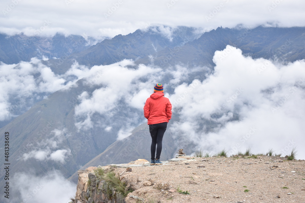 WOMAN IN MOUNTAIN AND CLOUDS IN PERU