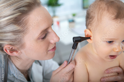 doctor checking baby ear with otoscope