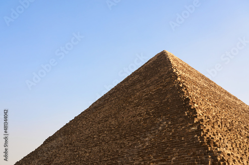 The pyramid of Cheops with a blue sky in the background.