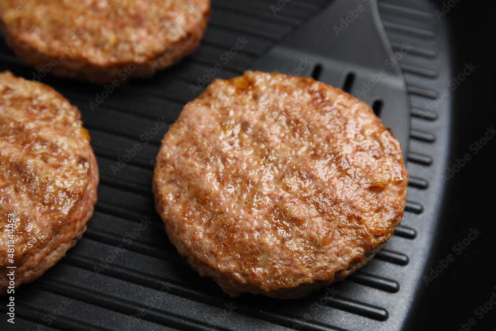 Tasty fried hamburger patties on grill pan, closeup Tasty fried hamburger patties on grill pan, closeup